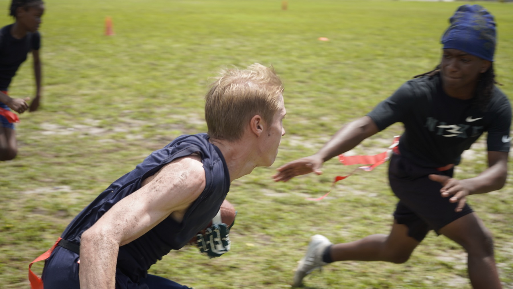 Athletes running a flag football drill
